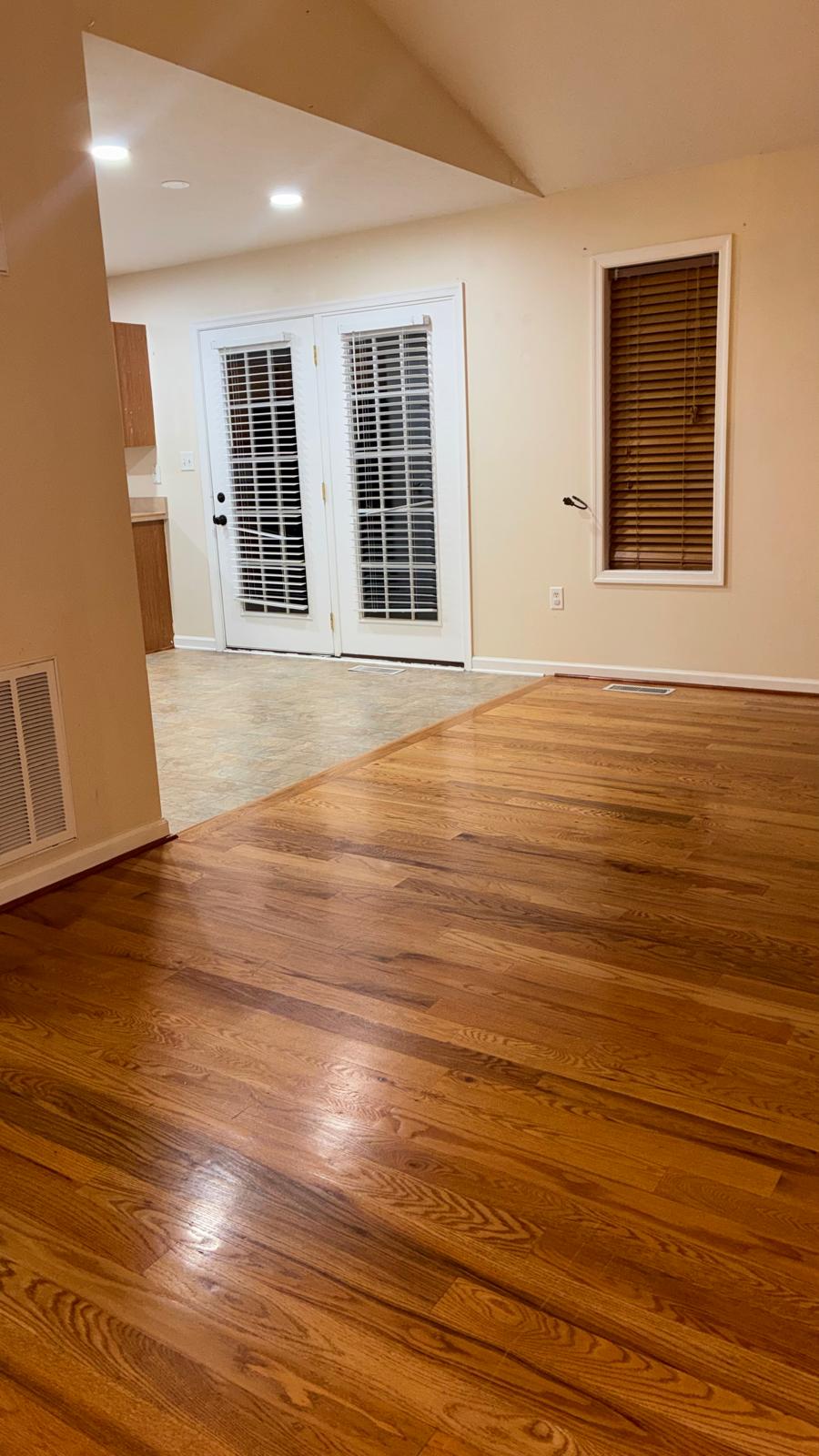 Empty room with freshly cleaned hardwood floors