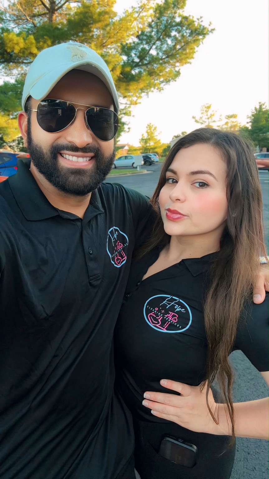 Two Hope Cleaning team members wearing branded shirts