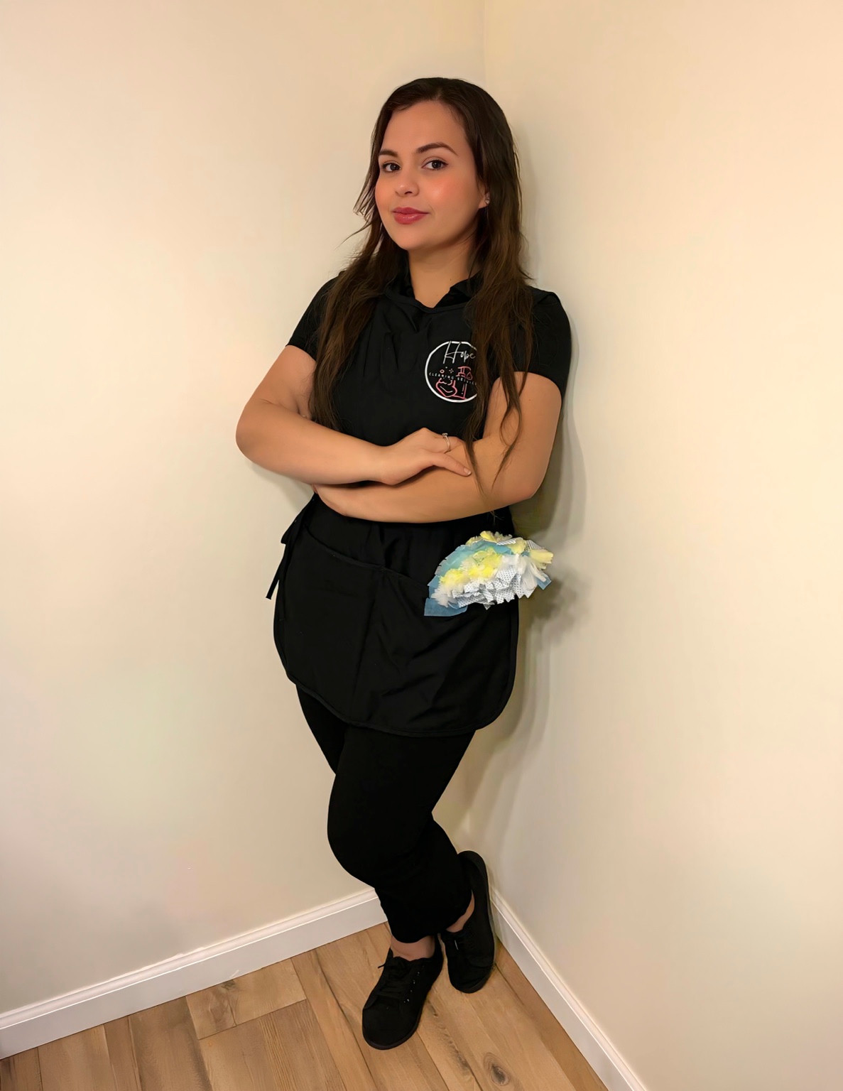 A Hope Cleaning team member in a branded uniform with a duster